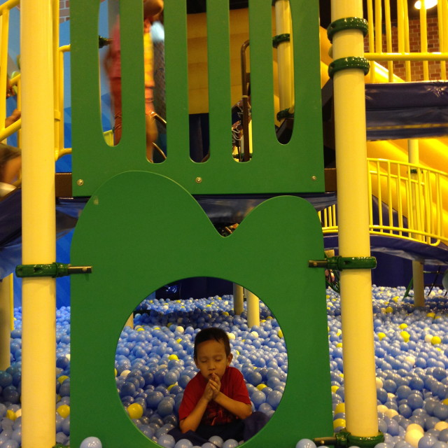 My son taking a breather in the playground before running around again.